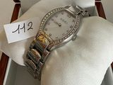 a watch in a box with a price tag on it