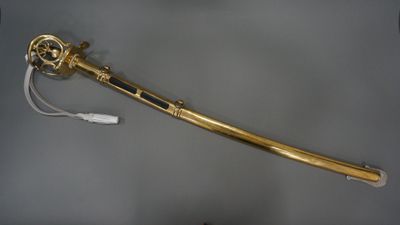 an old gold sword with a white handle and a black handle
