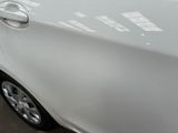 a white car with stickers on it parked in a parking lot