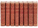 six livres rouges alignés sur une surface blanche