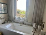 a bathtub in a bathroom with a view of the ocean