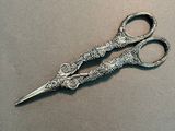 a pair of scissors sitting on top of a table