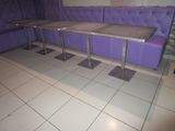 a purple couch and a table in the corner of a room