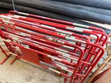 a red rack with baseball bats on top of it
