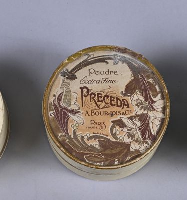 three small containers with decorative designs on them sitting on a table