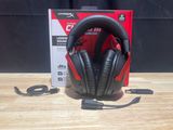 a close up of a pair of headphones sitting on top of a wooden table