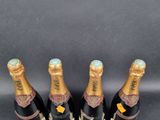 three bottles of champagne sitting on top of a black table