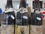 three bottles of wine sitting on top of a cardboard box