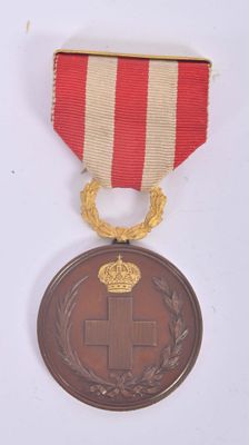 an image of a medal with a red cross on it