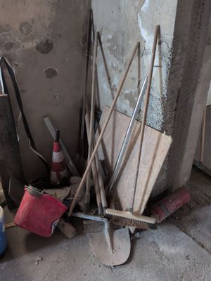a pile of tools sitting on the floor in the corner of a room