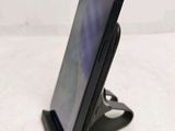 a cell phone that is on a stand on a table
