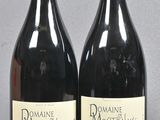 two bottles of wine sitting next to each other on a table