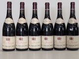 six bottles of wine are lined up on a table