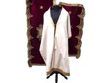 a white robe with gold trim on a mannequin stand