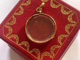 a small red box with a gold ring on it