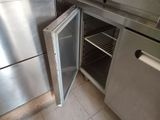 a small refrigerator with a door open in a kitchen