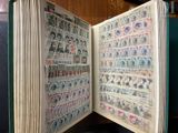 an open book with stamps on it sitting on a table