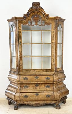 an old wooden display cabinet with glass doors and drawers