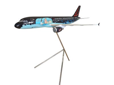 a model of an airplane on a stand on a white background