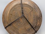 a wooden clock that has a black band around it
