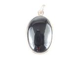 un gros plan d'un chat noir assis dans un pendentif en verre