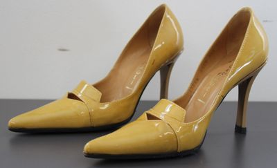 yellow high heeled shoes with a bow on the toe