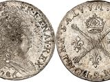 a silver coin with a crown on the front and a crown on the back