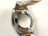 a close up of a watch on a white surface