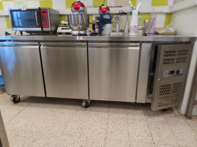 a stainless steel counter with a microwave on top of it