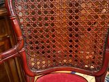 a red chair that has a red cushion on top of it