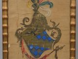 an old picture of a coat of arms is hanging on a wall