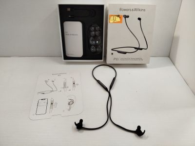 a box with ear buds and a charger on the table