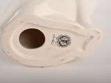 a white vase that has a hole in it
