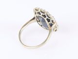 a close up of a ring with a blue stone in it