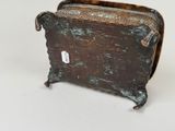a small metal box with a handle on a table