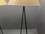 two lamps on a table with a lamp shade on top of them