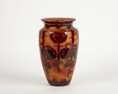 a brown vase with a red design on it