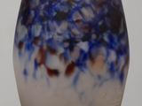 a blue and white vase sitting on top of a wooden table