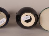 three black and white vases sitting next to each other on a table