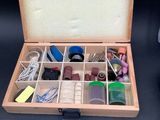 a wooden box with many different items inside of it