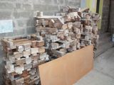 a pile of wood sitting next to a pile of bricks