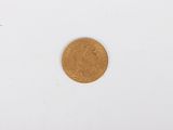 a close up of a gold coin on a white surface