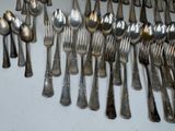 a lot of silver spoons and forks on the table