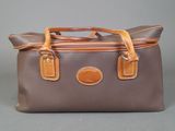 an image of a brown and tan bag on a gray background