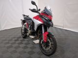 a red and white motorcycle parked on a black and white checkered floor