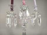 three candles that are sitting on a glass stand