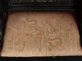 a wooden chair with a carved dragon on it