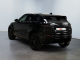 the black range rover is parked in a room with a white wall