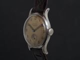 a close up of a watch on a black background