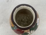 a small vase that is sitting in the snow